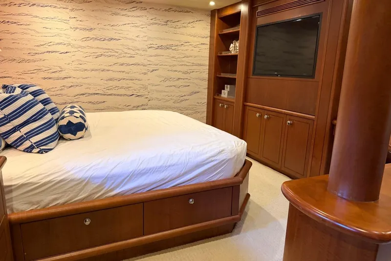 Slide: The Image of Luxurious bedroom interior on 1990 Heesen 144 yacht with wood furnishings and striped pillows. - 94