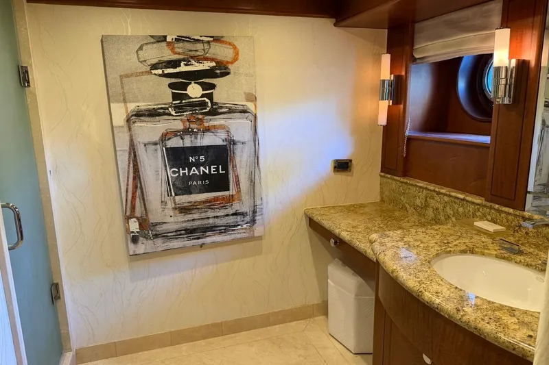 Slide: The Image of Luxurious yacht bathroom with Chanel artwork, granite countertop, and elegant lighting. Heesen 144, 1990. - 96