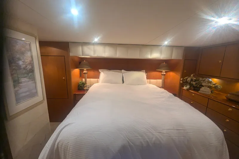 Slide: The Image of Luxurious bedroom interior of 2002 Ocean Yachts 56 Super Sport with elegant lighting and decor. - 14