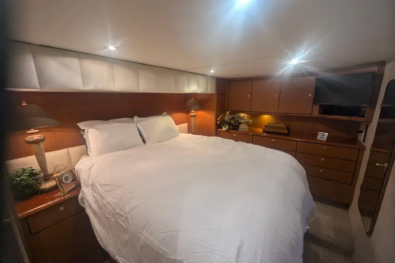 Slide: The Image of Luxurious bedroom interior of 2002 Ocean Yachts 56 Super Sport with elegant wood cabinetry. - 16