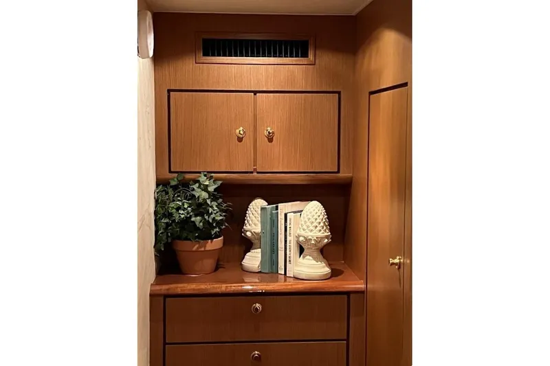 Slide: The Image of Interior of 2002 Ocean Yachts 56 Super Sport with wooden cabinetry and decorative items. - 17