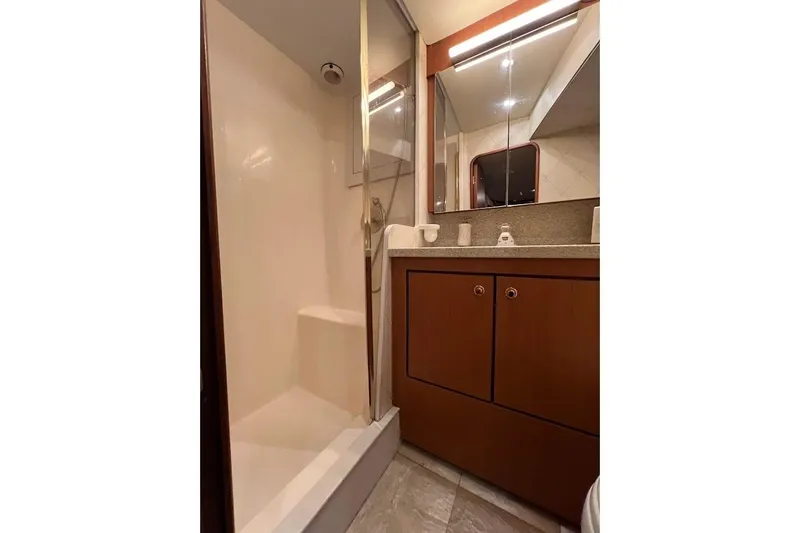 Slide: The Image of Bathroom interior of 2002 Ocean Yachts 56 Super Sport with shower and wooden cabinetry. - 18