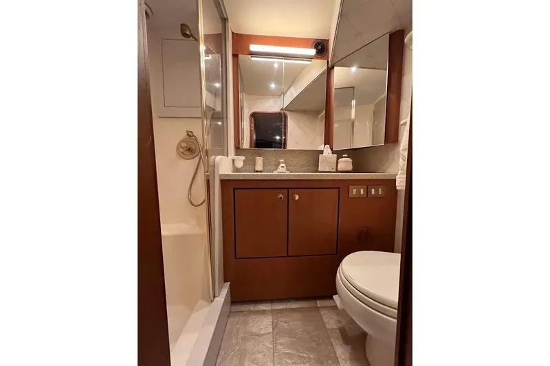 Slide: The Image of Luxurious bathroom in 2002 Ocean Yachts 56 Super Sport, featuring elegant wood cabinetry. - 19