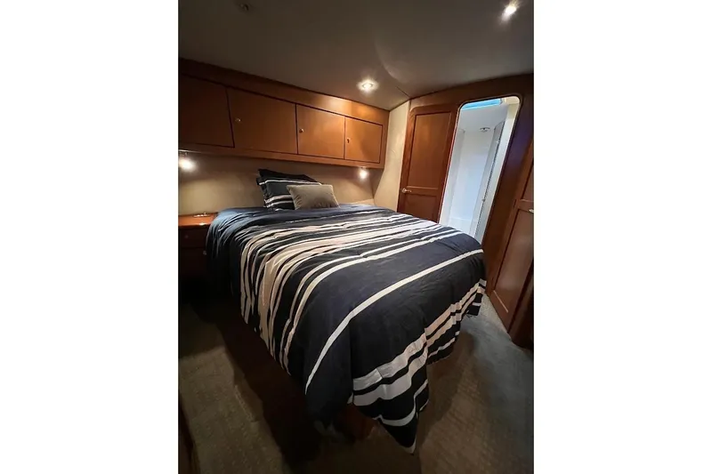 Slide: The Image of Luxurious bedroom interior of 2002 Ocean Yachts 56 Super Sport with striped bedding. - 20