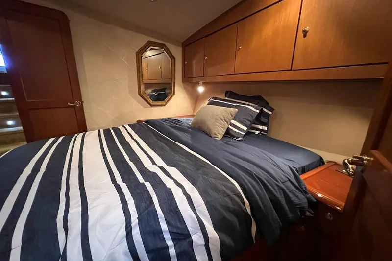 Slide: The Image of Luxurious bedroom interior of 2002 Ocean Yachts 56 Super Sport with striped bedding. - 21