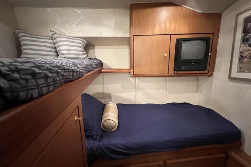 Slide: The Image of Cozy cabin interior of 2002 Ocean Yachts 56 Super Sport with bunk beds and TV. - 26