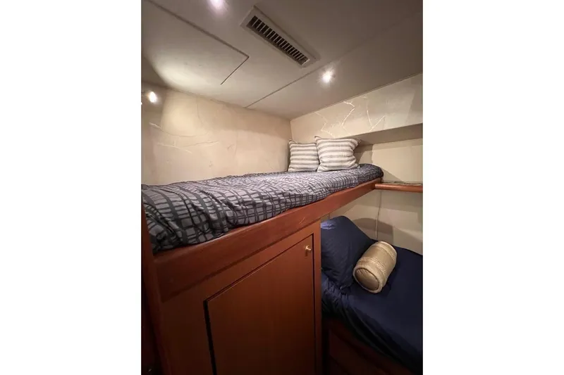 Slide: The Image of 2002 Ocean Yachts 56 Super Sport cabin with bunk beds and cozy lighting. - 27