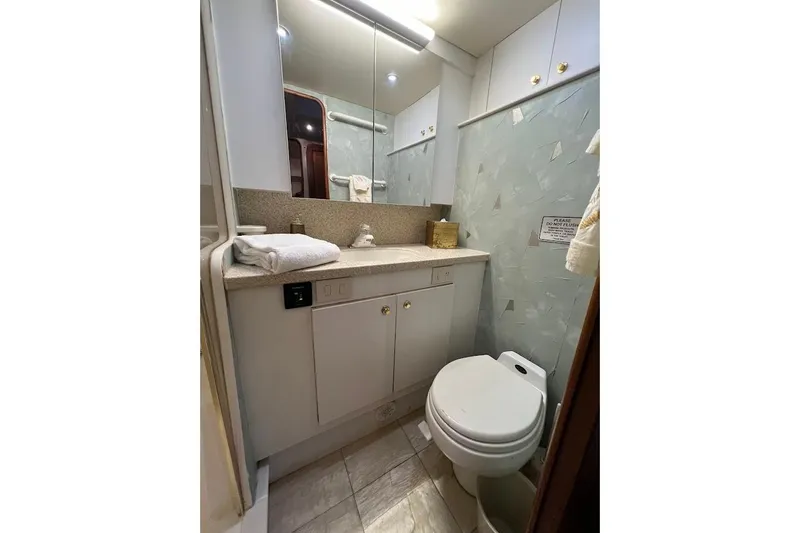 Slide: The Image of Luxurious bathroom in 2002 Ocean Yachts 56 Super Sport, featuring modern fixtures and elegant design. - 28