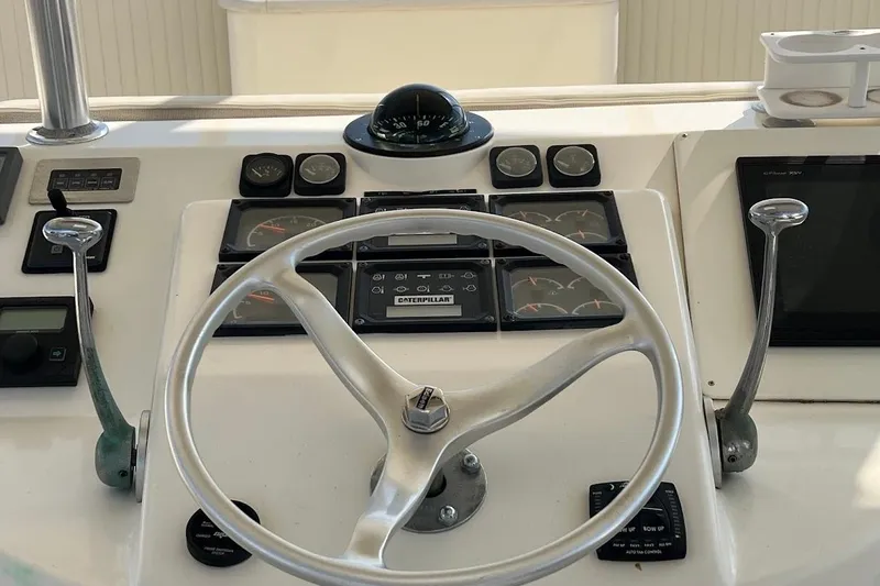 Slide: The Image of Helm of 2002 Ocean Yachts 56 Super Sport with steering wheel and control panel. - 30