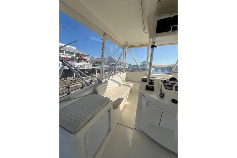 Slide: The Image of 2002 Ocean Yachts 56 Super Sport interior with helm and seating area, dockside view. - 34