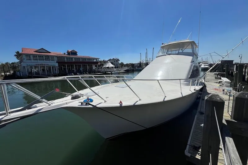 Slide: The Image of 2002 Ocean Yachts 56 Super Sport docked at marina under clear blue sky. - 50