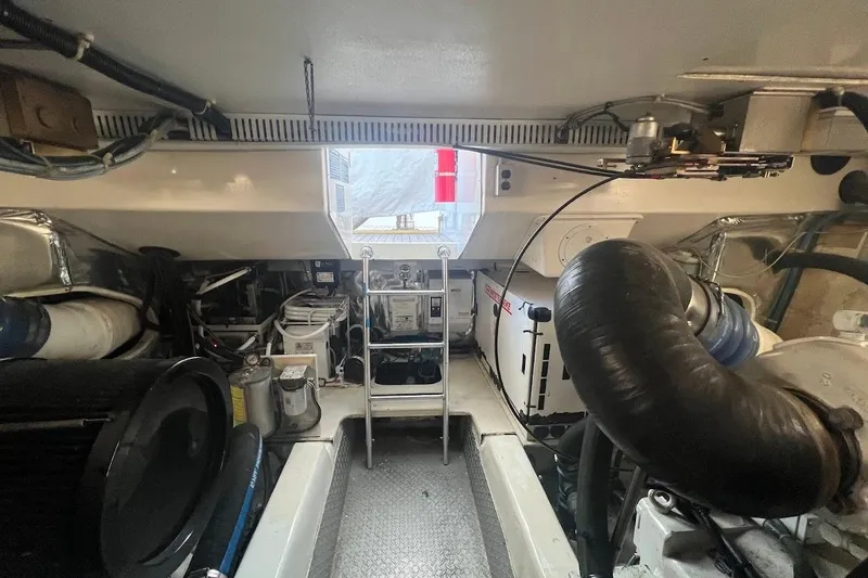 Slide: The Image of Engine room of a 2002 Ocean Yachts 56 Super Sport, showcasing mechanical components and equipment. - 59