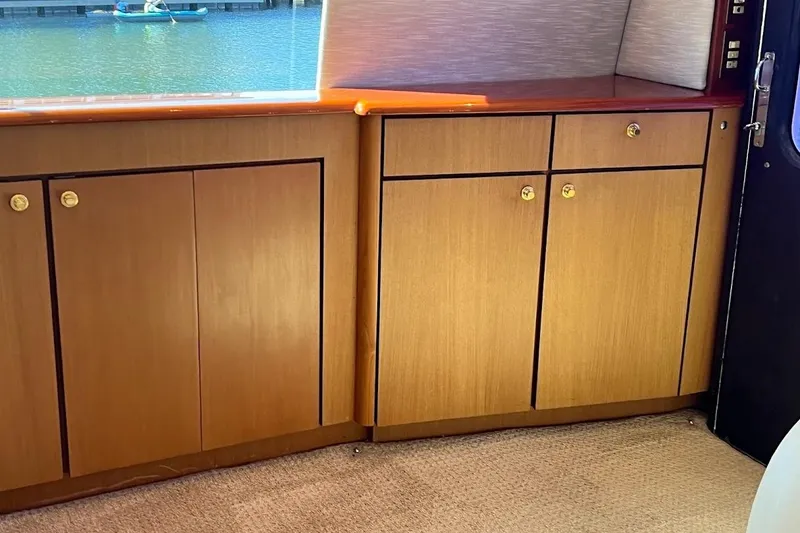 Slide: The Image of Interior view of 2002 Ocean Yachts 56 Super Sport with wooden cabinets and carpet flooring. - 6