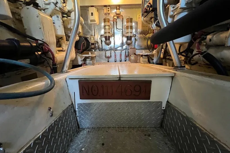 Slide: The Image of Engine room of 2002 Ocean Yachts 56 Super Sport, showcasing mechanical components and serial number. - 62