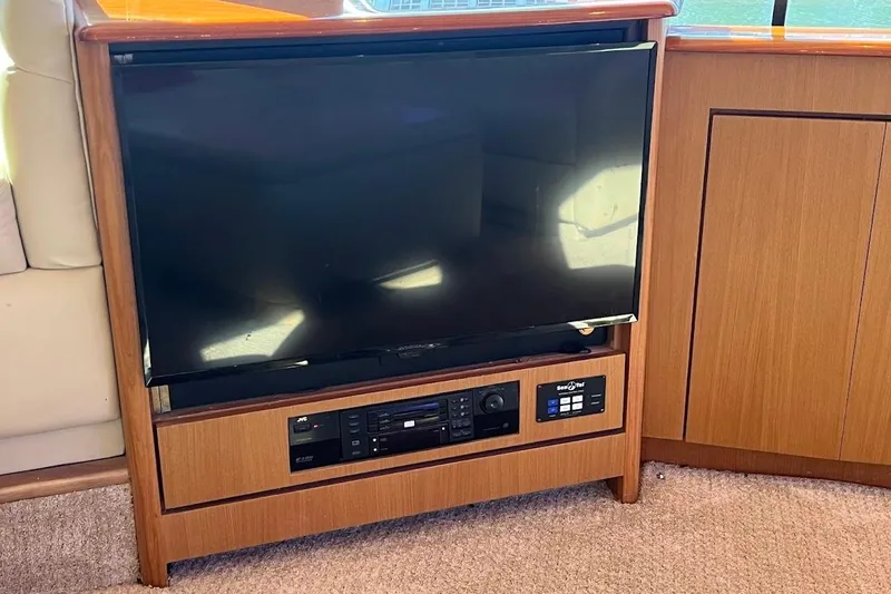 Slide: The Image of Entertainment system on 2002 Ocean Yachts 56 Super Sport, featuring a TV and audio controls. - 7