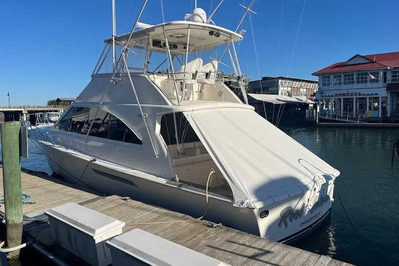 Slide: The Image of 2002 Ocean Yachts 56 Super Sport docked at marina, sunny day, waterfront buildings. - 79