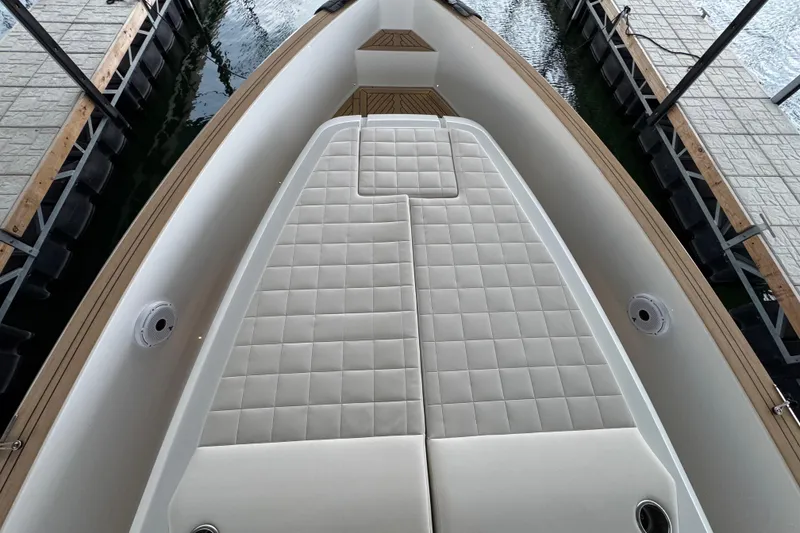 Slide: The Image of 2025 Pardo Yachts P38 deck with cushioned seating, docked at marina. - 18