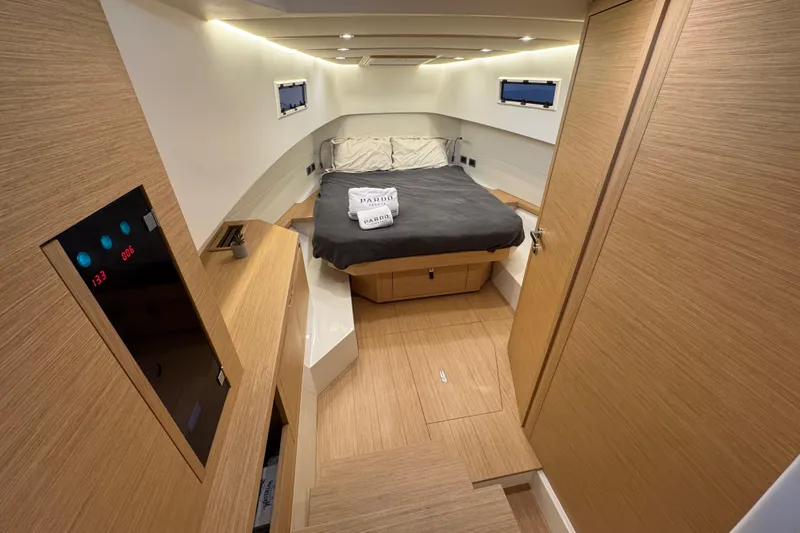 Slide: The Image of Luxurious cabin interior of 2025 Pardo Yachts P38, featuring modern wood finishes and cozy bedding. - 19