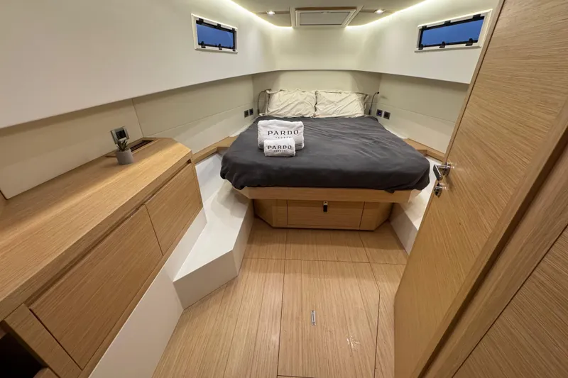 Slide: The Image of Luxurious cabin interior of 2025 Pardo Yachts P38, featuring modern wood finishes and cozy bedding. - 22