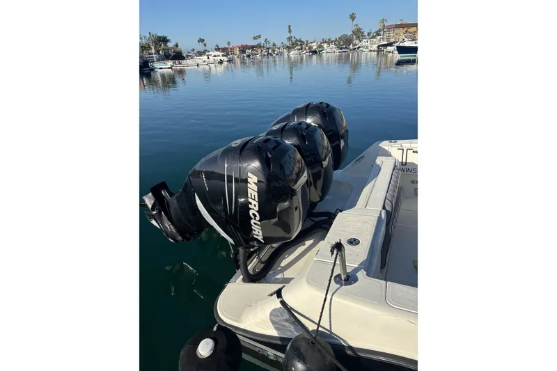 Slide: The Image of 2004 Hydra-Sports 3400 CC boat with triple Mercury outboard engines in a marina setting. - 4
