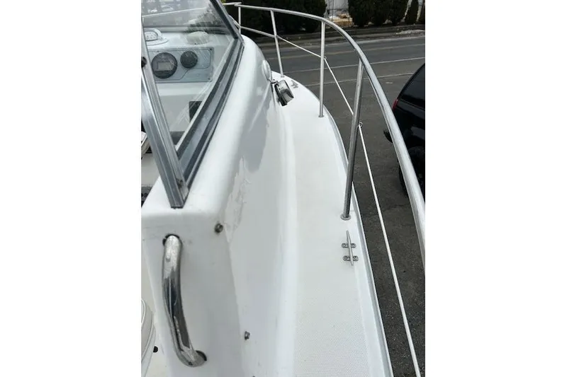 Slide: The Image of 2005 Sea Fox 230 Walk Around boat dashboard with steering wheel and gauges. - 12