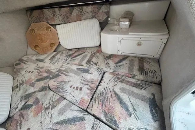 Slide: The Image of 2005 Sea Fox 230 Walk Around boat cockpit with dual seats and steering wheel. - 14