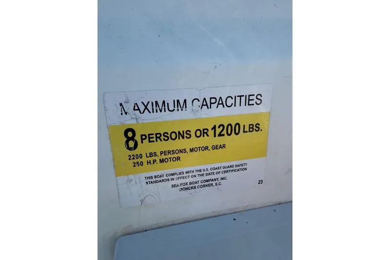 Slide: The Image of 2005 Sea Fox 230 Walk Around capacity label: 8 persons or 1200 lbs, 250 HP motor. - 27