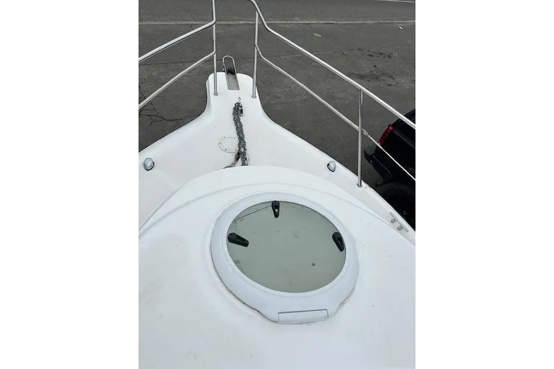 Slide: The Image of 2005 Sea Fox 230 Walk Around boat with canopy and railing, side view. - 5
