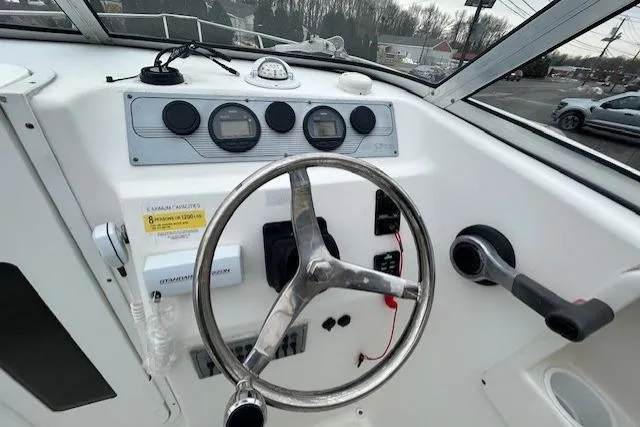 Slide: The Image of 2005 Sea Fox 230 Walk Around boat with 200 horsepower outboard motor. - 7