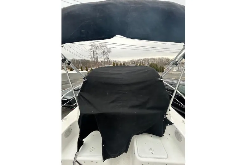 Slide: The Image of 2005 Sea Fox 230 Walk Around boat on trailer, parked outdoors under clear sky. - 8