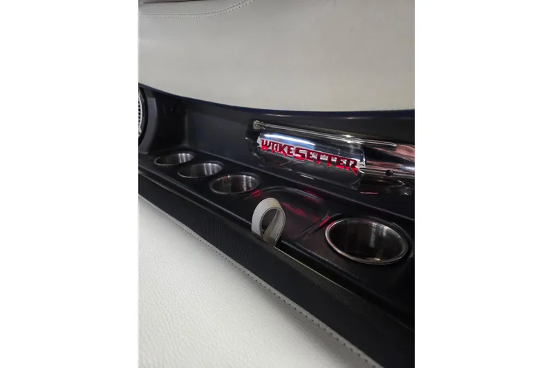Slide: The Image of Interior of 2013 Malibu Wakesetter 22 MXZ with cup holders and logo detail. - 11