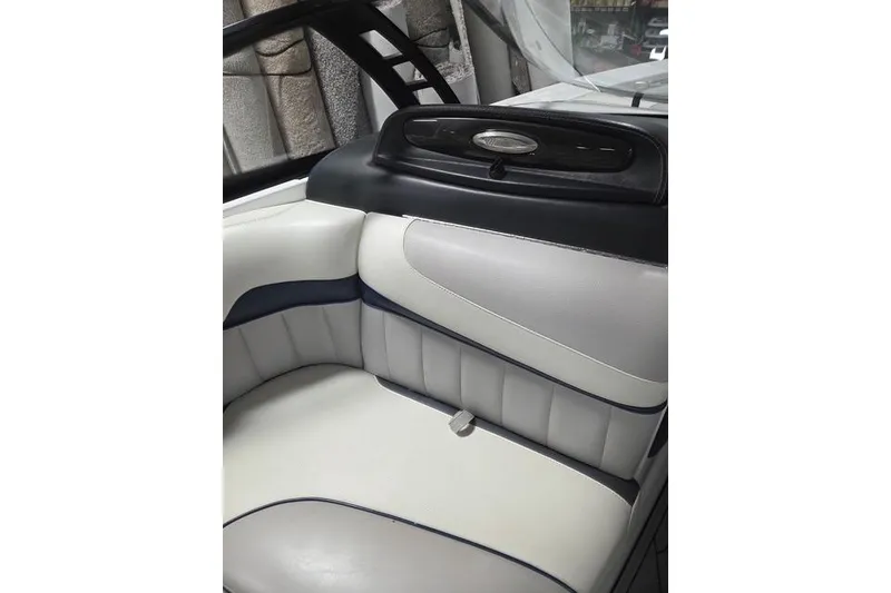 Slide: The Image of 2013 Malibu Wakesetter 22 MXZ interior seating with sleek white and black design. - 14