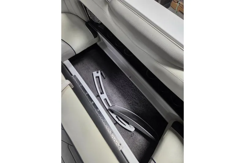 Slide: The Image of 2013 Malibu Wakesetter 22 MXZ interior storage compartment with accessories. - 15