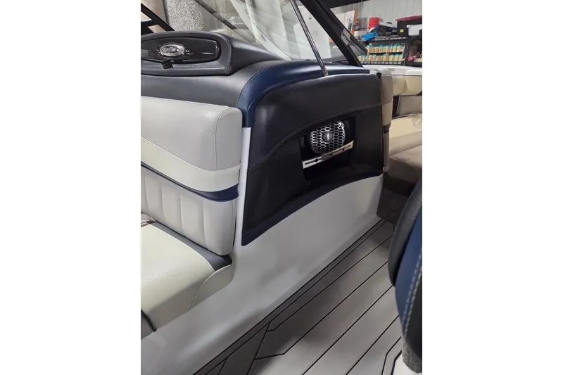 Slide: The Image of 2013 Malibu Wakesetter 22 MXZ interior with sleek seating and built-in speaker. - 22