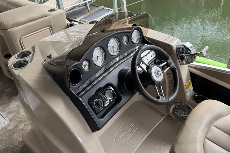 Slide: The Image of Steering console of a 2010 Harris Grand Mariner 250 boat with gauges and controls. - 11