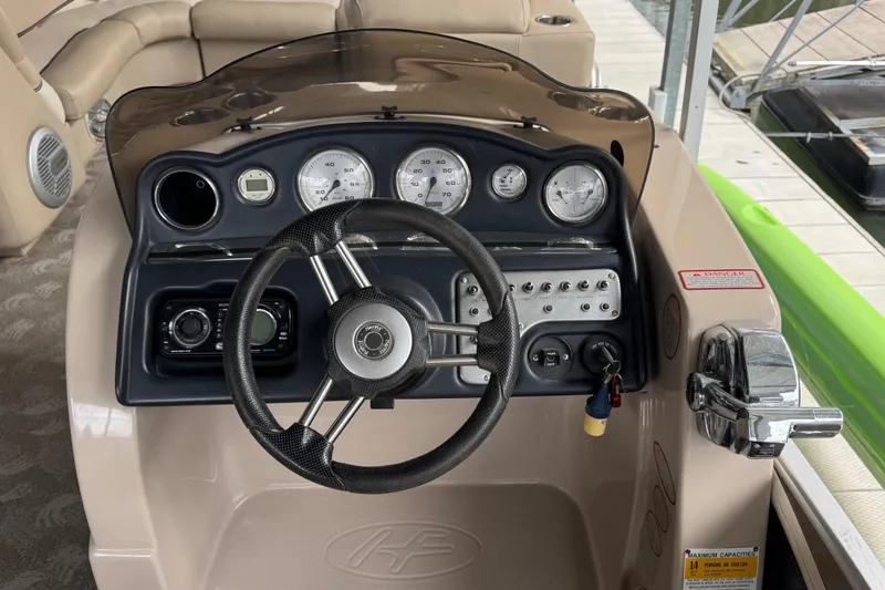 Slide: The Image of Steering console of 2010 Harris Grand Mariner 250 boat with gauges and controls. - 13