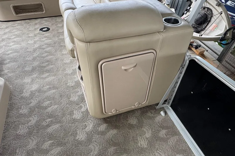 Slide: The Image of 2010 Harris Grand Mariner 250 interior with beige seating and carpeted flooring. - 20