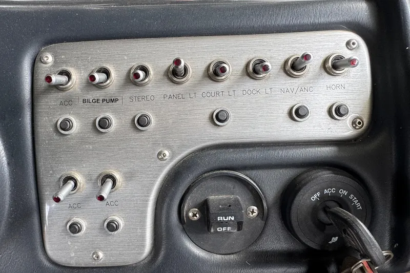 Slide: The Image of Control panel of a 2010 Harris Grand Mariner 250 boat with switches and ignition. - 24