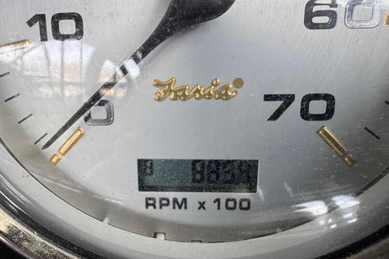 Slide: The Image of Close-up of a Faria tachometer showing 883.9 RPM on a 2010 Harris Grand Mariner 250. - 27
