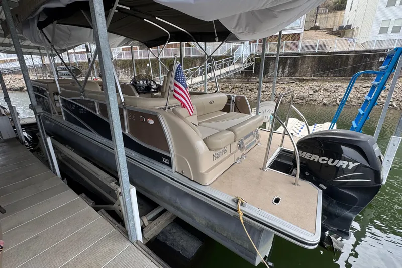 Slide: The Image of 2010 Harris Grand Mariner 250 pontoon boat docked with Mercury outboard motor. - 4