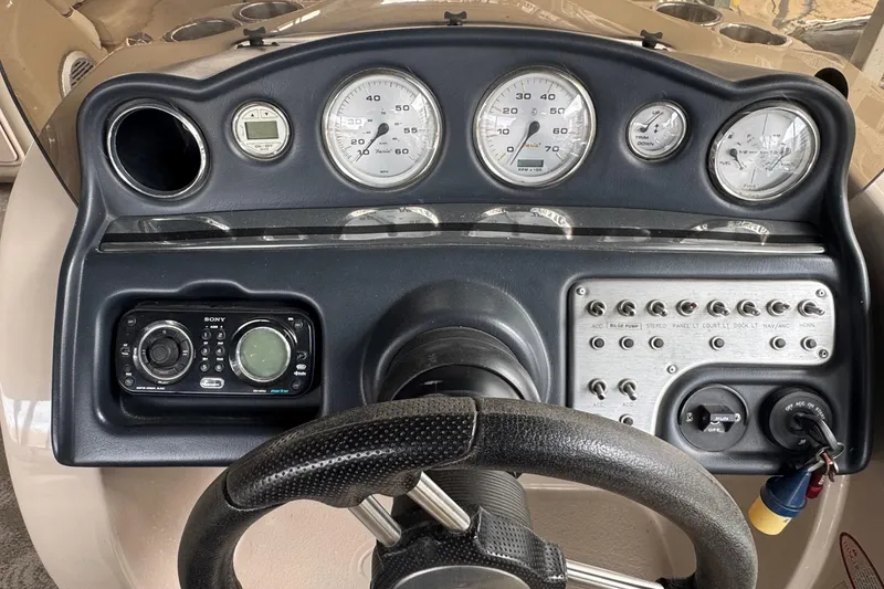 Slide: The Image of Dashboard of a 2010 Harris Grand Mariner 250 boat with gauges and controls. - 7