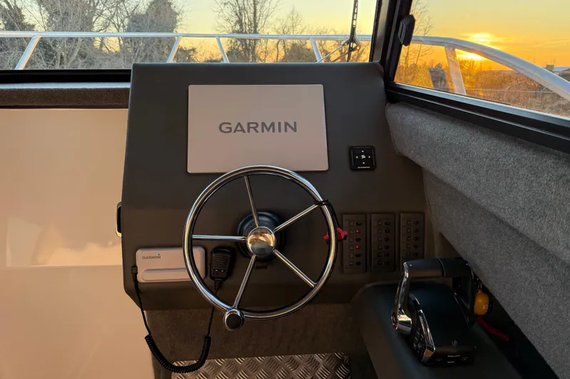 Slide: The Image of Helm of 2026 Makaira Gen3 26 Outboard with Garmin navigation, sunset view. - 25