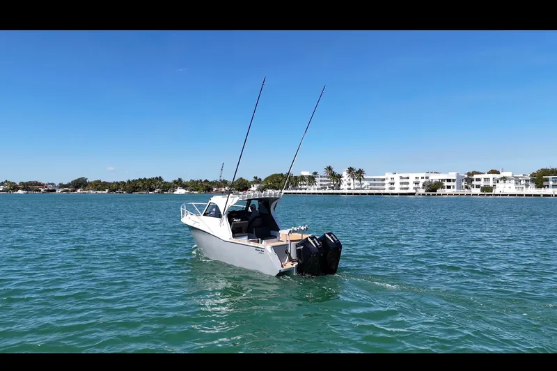 Slide: The Image of Makaira Gen3 26 Outboard 2026 boat on water, clear sky, coastal background. - 3