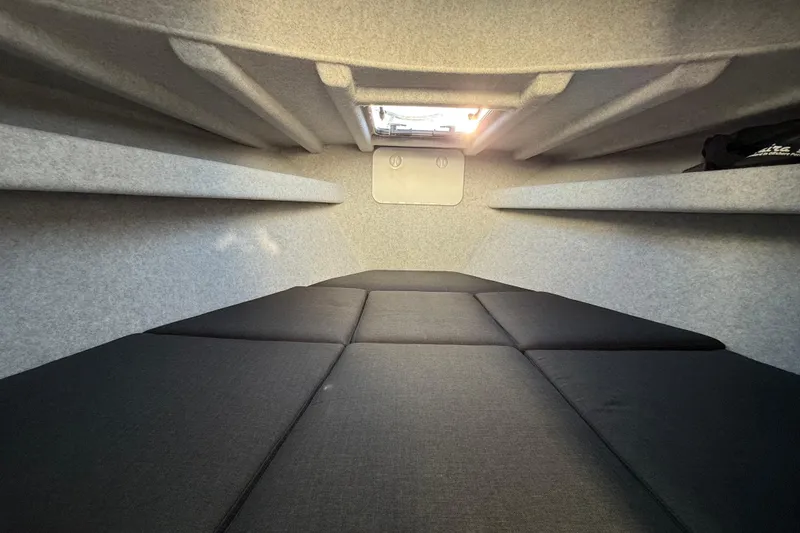 Slide: The Image of Interior cabin of 2026 Makaira Gen3 26 Outboard boat, featuring cushioned seating. - 36