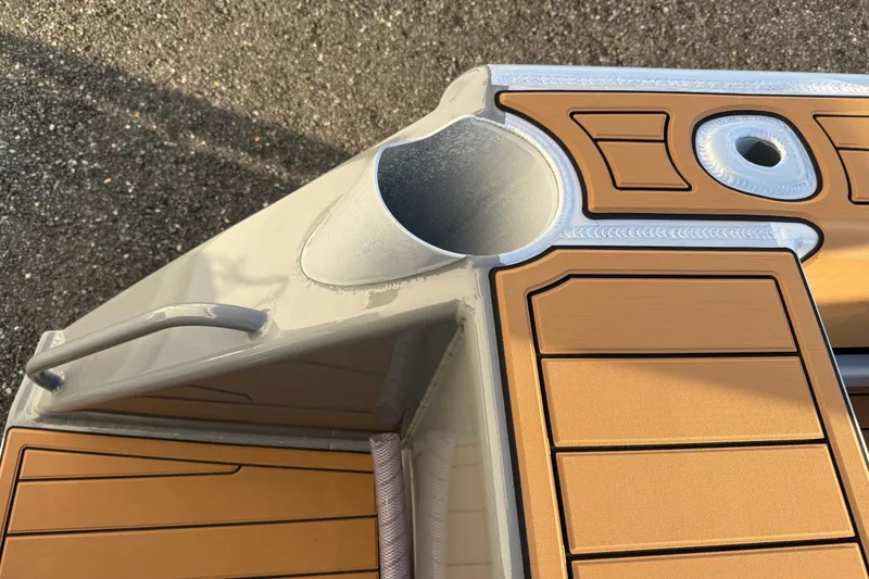 Slide: The Image of Makaira Gen3 26 Outboard 2026 boat deck with cup holder and teak-style flooring. - 45