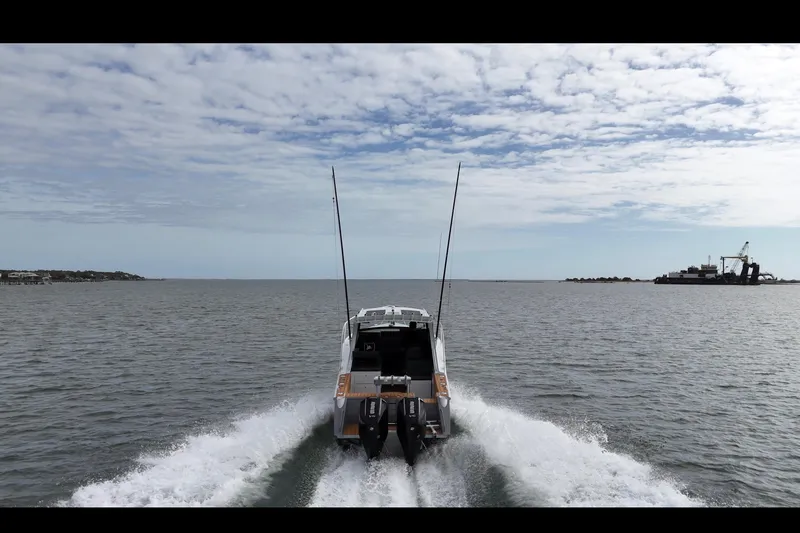 Slide: The Image of 2026 Makaira Gen3 26 Outboard cruising on open water under a partly cloudy sky. - 5