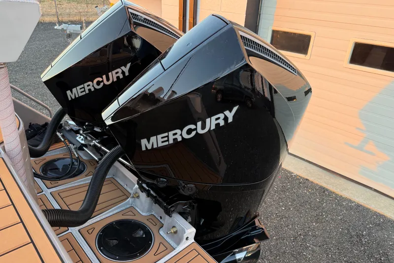 Slide: The Image of Twin Mercury outboard engines on a 2026 Makaira Gen3 26 boat, dockside view. - 53