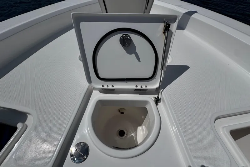 Slide: The Image of Open storage compartment on 2025 Blackwater 23 Bay boat deck. - 10