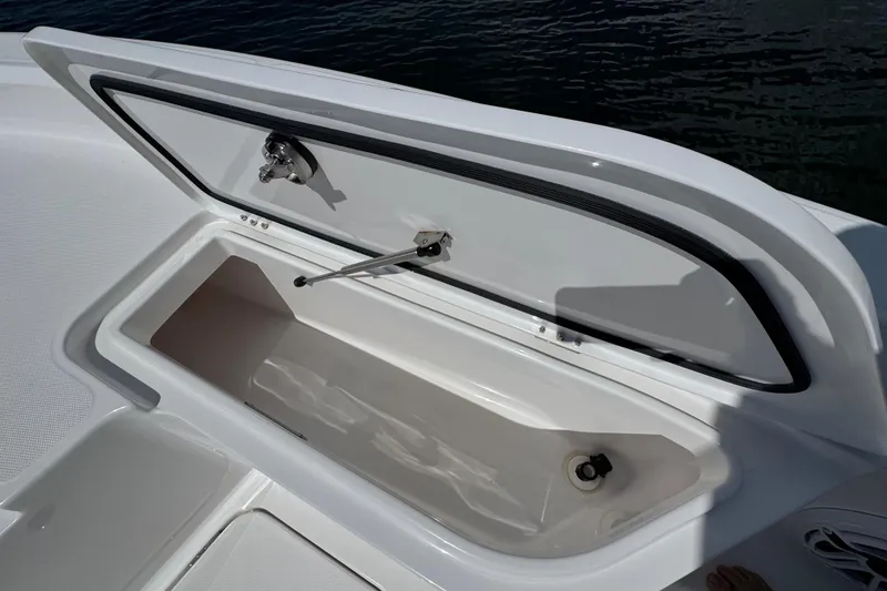 Slide: The Image of Open storage compartment on 2025 Blackwater 23 Bay boat, showing interior details. - 12