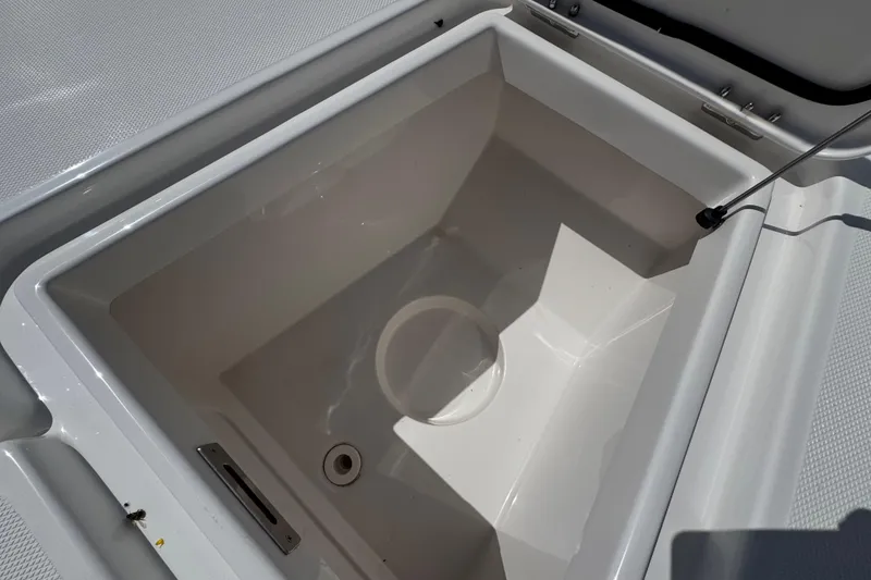 Slide: The Image of Open storage compartment on 2025 Blackwater 23 Bay boat, showcasing interior design. - 13